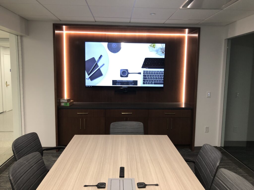Executive boardroom AV system with large-format displays and conferencing cameras