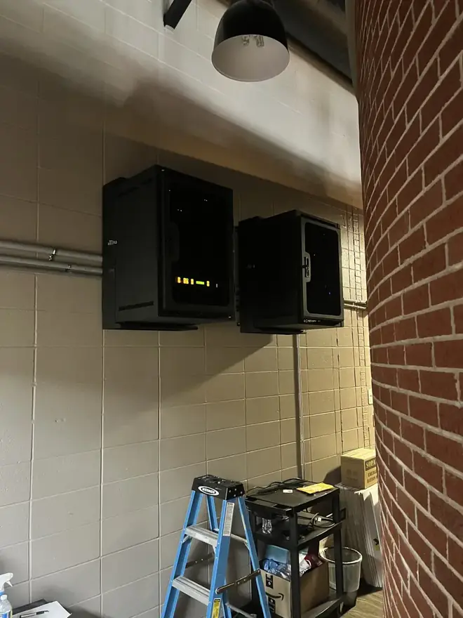 Compact wall-mounted AV equipment enclosures installed by Go Media