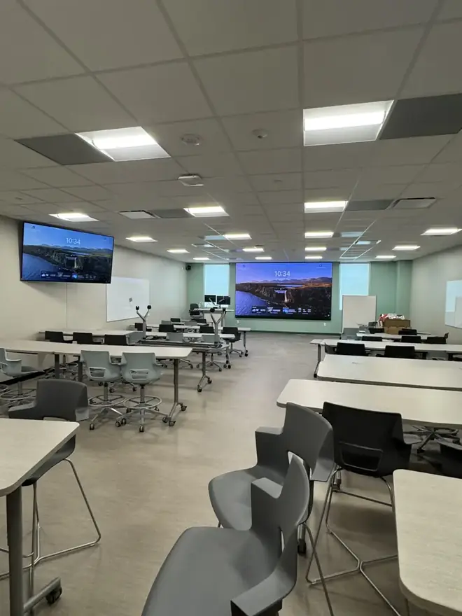 Training room with large displays and video conferencing installed by Go Media